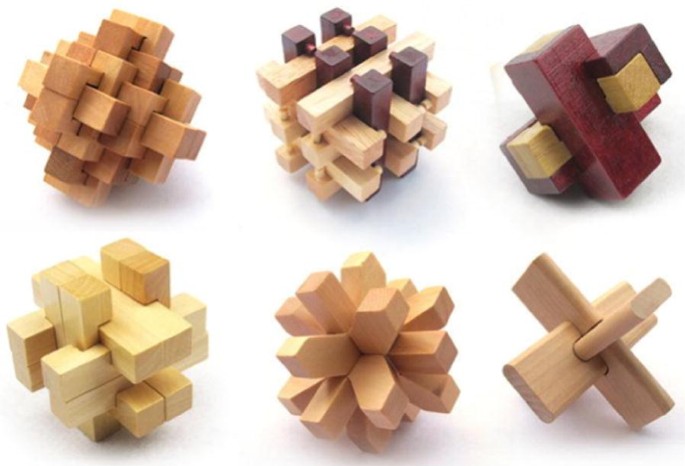 A set of interlocking wooden puzzle pieces, illustrating how interlocking parts stay connected the way a Rubik's Cube mechanism does